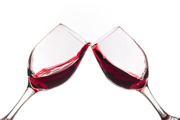 Cheers. Two glasses clicking together on white background. Splashing red wine on balloon glasses
