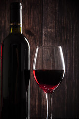 wine glass with red wine on wooden table