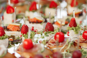Canape appetizers with strawberries and Brie soft cheese