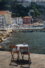 Coffee table and chairs in a cozy place. Coffee break in Italy, in Sorrento. Rest by the sea.