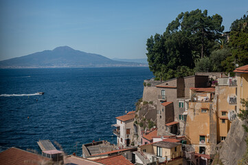 View of the sea and Mount Vesuvius through the old tiled roofs.
