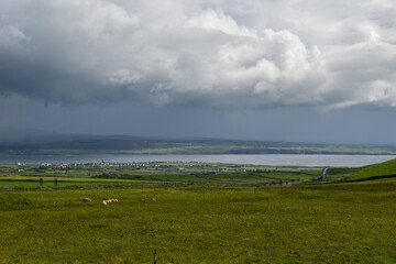 Aran Islands irish landscape with houses, boats and a cemetery
