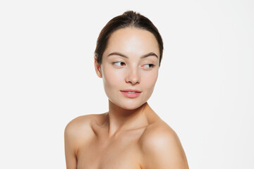 Portrait of beautiful tender woman with smooth clear skin isolated over white studio background. Cosmetics