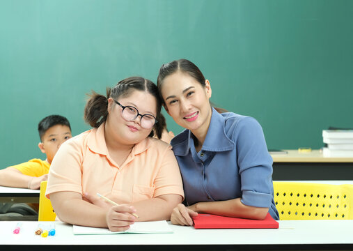 Cute Girl, Autism Or Intellectual Disablity And Teacher Smiling In Classroom