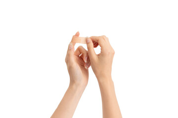 Young woman sticking plaster to injured place on her hand. Injury treatment, first aid concept.