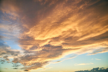 Colorful sky during sunset. Clouds are illuminated by sunlight. High quality photo