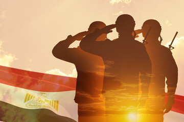 Double exposure of Silhouettes of soliders and the sunset or the sunrise against flag of Egypt....