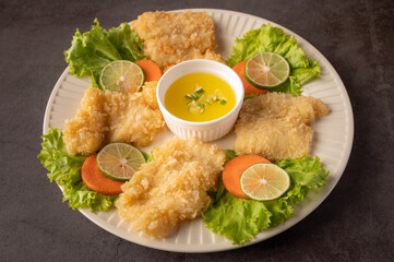 White plate with fish fried, lemon sauce