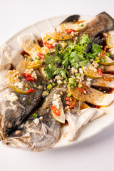 Steamed bass fish with spicy soya sauce, chinese style red background