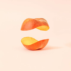Creative composition with levitating halved peach against pastel powder background. Jin and jang concept. Balanced vegan diet idea. - obrazy, fototapety, plakaty