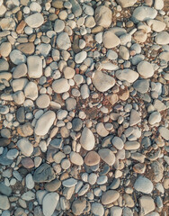 Seashore, pebble beach with large boulders. Rocky shore. Natural background, stone organic texture.