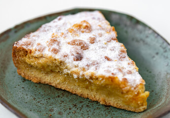 tasty pie in ceramic plate on white wooden desk
