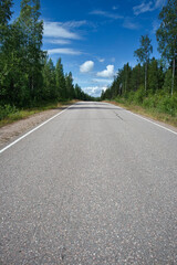 Empty asphalt road in rural landscape, Finland