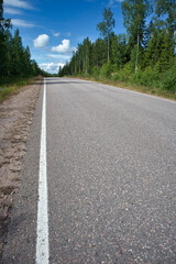 Fototapeta na wymiar Empty asphalt road in rural landscape, Finland