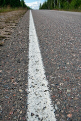 Empty asphalt road in rural landscape, Finland