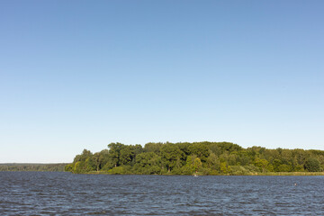 Lake in summer. Large lake and forest on horizon. Water landscape without unnecessary details. Lots of water.