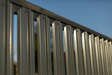 Steel fence. Fence is silver in color. Steel obstacle.