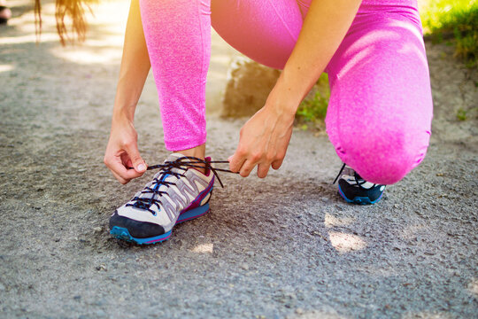 Running shoes - closeup of woman tying shoe laces. Woman tying shoe laces