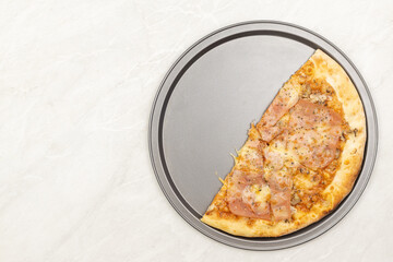 Top view of sliced pizza on the plate with copy space