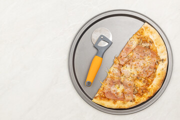 Top view of sliced pizza on the plate with copy space
