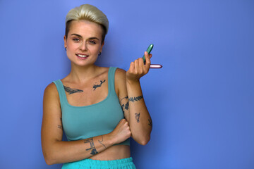 Short haired girl standing with two vibrator for clitoral vaginal stimulation