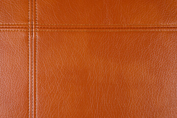 Natural, artificial brown leather texture background with decorative seam. Material for sport...