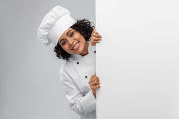cooking, advertisement and people concept - happy smiling female chef in toque with white board...
