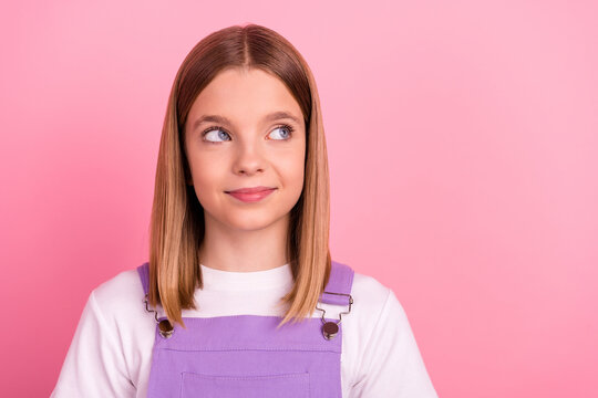 Photo of young pretty girl with creative imagination look empty space fantasizing isolated on pink color background