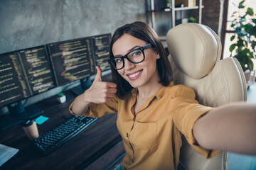 Self-portrait of attractive smart clever cheerful girl cyber engineer showing thumbup solution at...