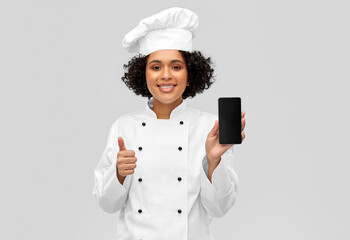 cooking, culinary and people concept - happy smiling female chef in toque and jacket showing...