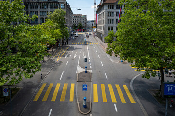 A yellow zebra pedestrian crosswalk in Zurich city Switzerland. Low traffic, high viewpoint, sunny...