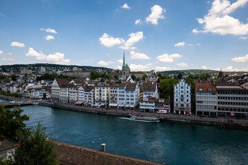 Fototapeta na wymiar Zurich city old town vista from a high viewpoint. Sunny summer day, a cathedral in the background