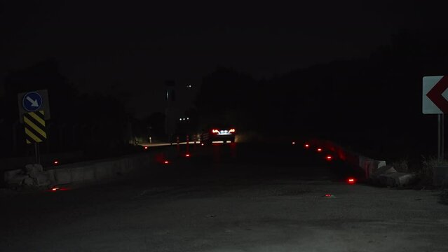 Red lights built into the road. Night road. Signal lights. car driving on a night road