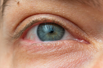 Obraz premium Wide open Caucasian male eye. Close up shot portrait, unrecognizable face