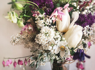 Bouquet with lilac, tulips, tarantula, daffodils, dicentra, aquilegia
