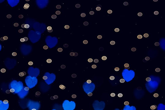 Bokeh festive leack  blue heart symbol on dark  background 