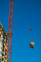 Fototapeta na wymiar crane at the construction site moves the load