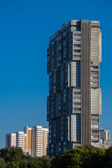 Fototapeta na wymiar apartment building of experimental architecture against the sky