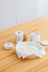 White Candles of Different Sizes and Shapes on Table. Minimalism Natural Decor in Interior.