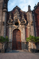 Facade detail and entry door at Metropolitan Cathedral in Zocalo, Center of Mexico City, Mexico. This grand Roman Catholic cathedral with many ornate chapels is Latin America's oldest and largest.