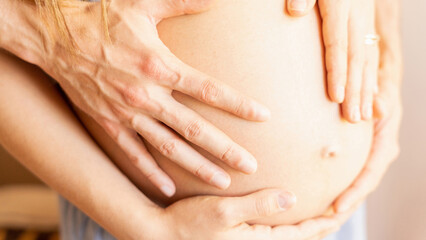 Pregnant couple belly hands. Happy pregnancy woman and husband hugging pregnant belly. Concept of pregnancy, maternity, expectation for baby birth.