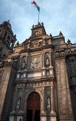 Facade detail with the clock tower at Metropolitan Cathedral in Zocalo, Center of Mexico City, Mexico. This Roman Catholic cathedral with many ornate chapels is Latin America's oldest and largest.