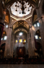 Fototapeta premium Beautiful light from the dome above and great Neo-Classical architecture of the interior at the Metropolitan Cathedral in Zocalo, Center of Mexico City, Mexico..