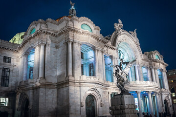 Side view of the Palace of Fine Arts (Palacio de Bellas Artes) beautifully Illuminated at night - Dramatic marble performance hall, exhibition venue, museum and theatre in Mexico City, Mexico. - obrazy, fototapety, plakaty