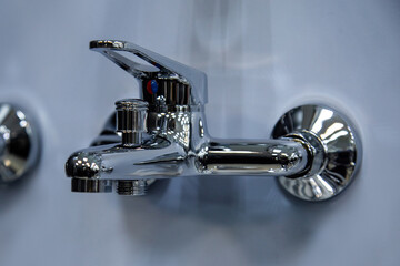 shower faucet chrome-plated on a blue background