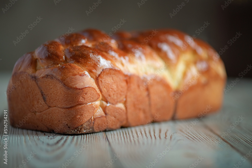 Wall mural fresh baked homemade organic bread close-up on a wooden background.