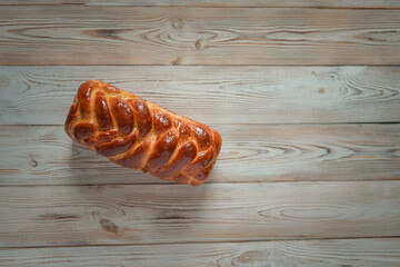 Fresh baked homemade organic bread close-up on a wooden background.