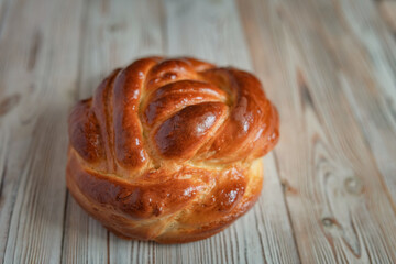 Fresh baked homemade organic bread close-up on a wooden background.