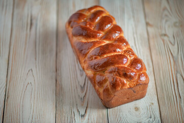 Fresh baked homemade organic bread close-up on a wooden background.