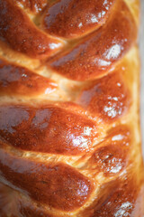 Fresh baked homemade organic bread close-up on a wooden background.